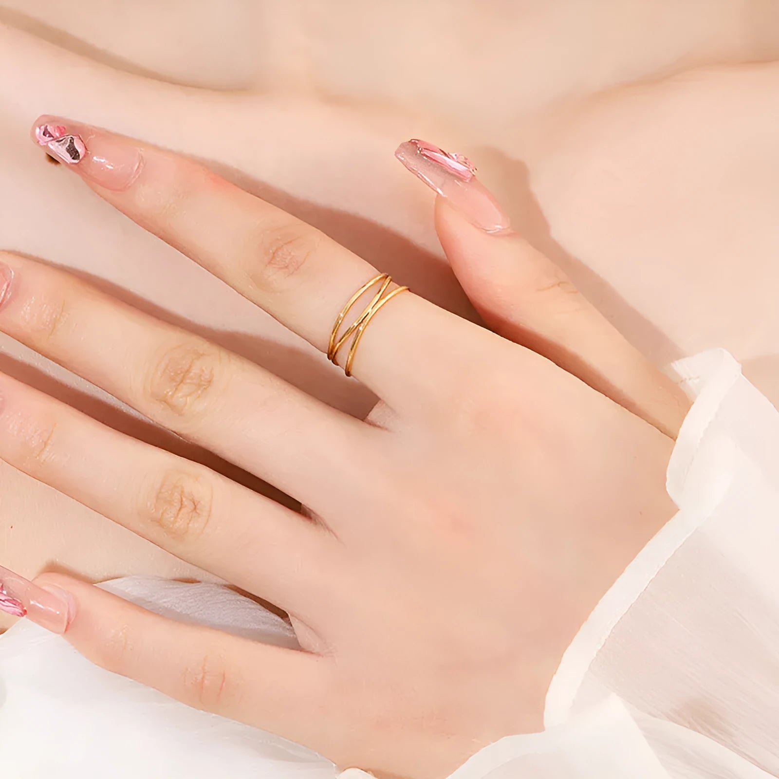 Gold geometric line ring with three-layer coil design on finger