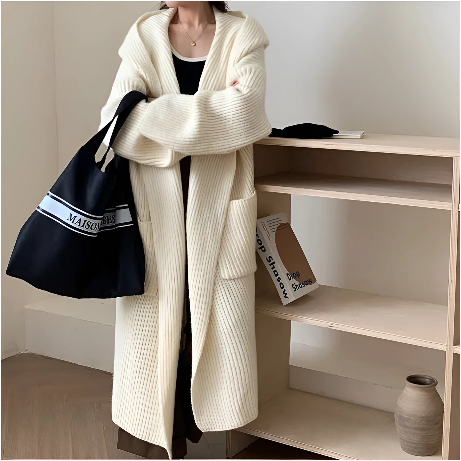 Loose hooded acrylic cardigan sweatshirt in milky white colour showing raglan sleeves and 80cm length