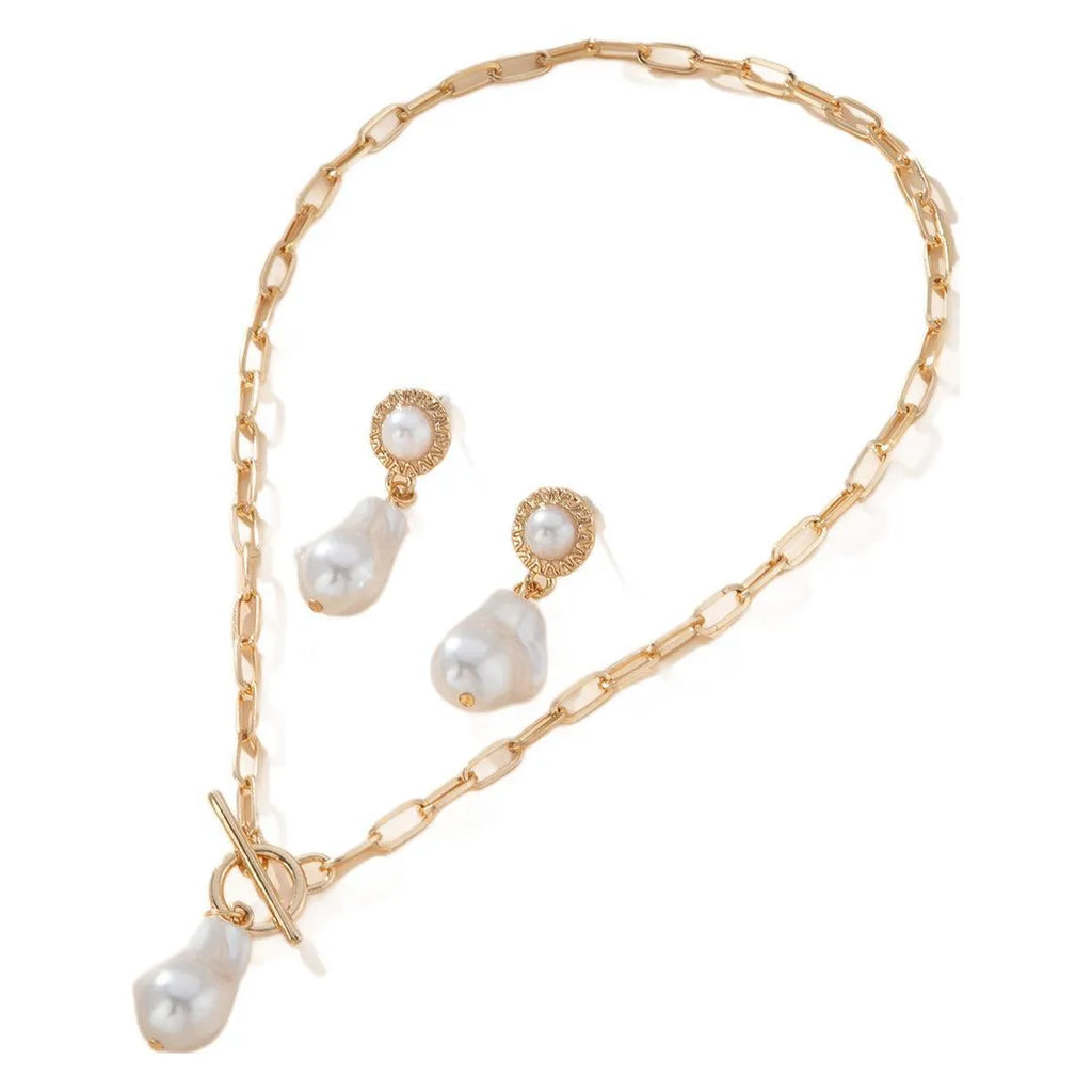 Gold-coloured retro baroque pearl pendant necklace and matching stud earrings set on a dark background.