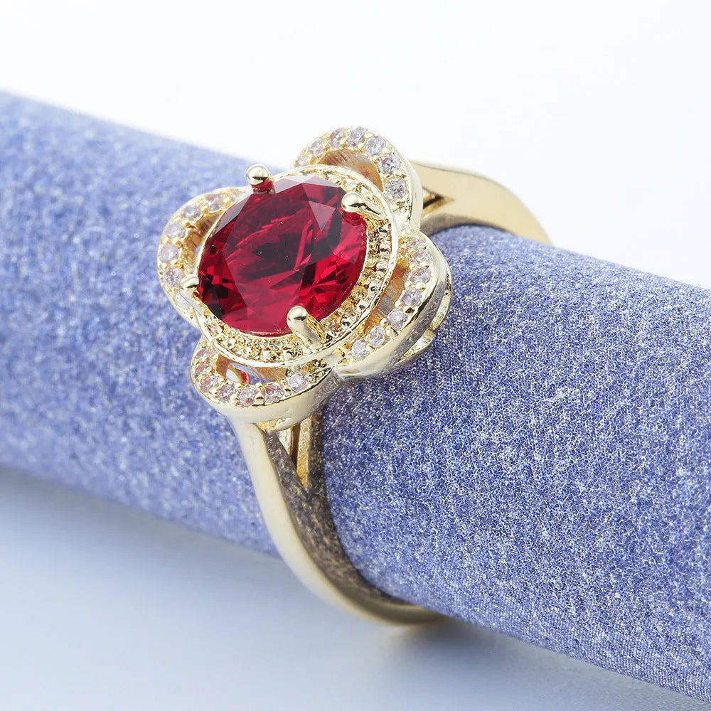 Copper fruit-shaped ring with electroplated zircon detailing on a hand.