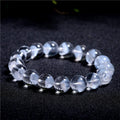 White crystal pyramid bracelet with natural ghost charm and Ruyi symbol detail on wrist