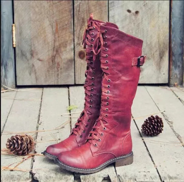 Chunky low heel high leg boots in black, brown, and wine red with rounded toe.