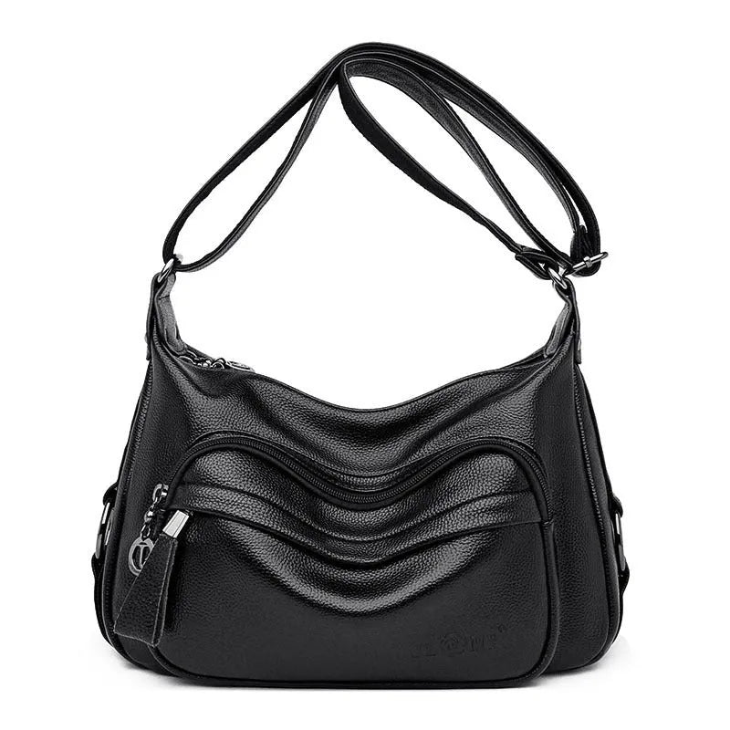 Large black PU shoulder bag with multiple internal compartments showing phone and document sections