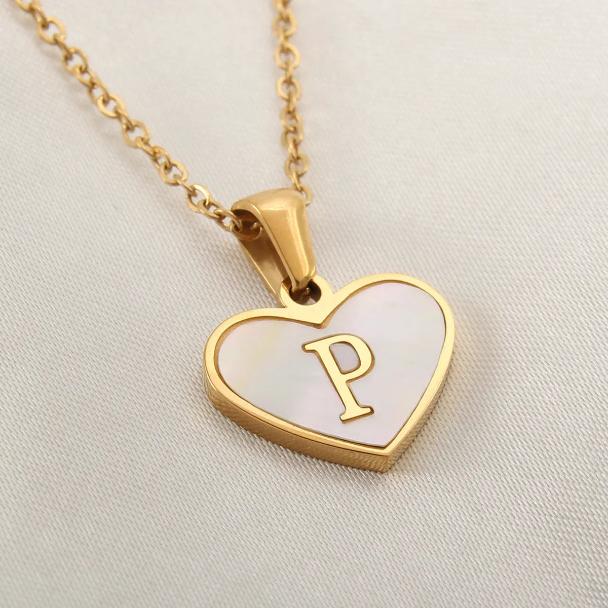 Gold plated heart-shaped necklace with white shell pendant on adjustable stainless steel chain