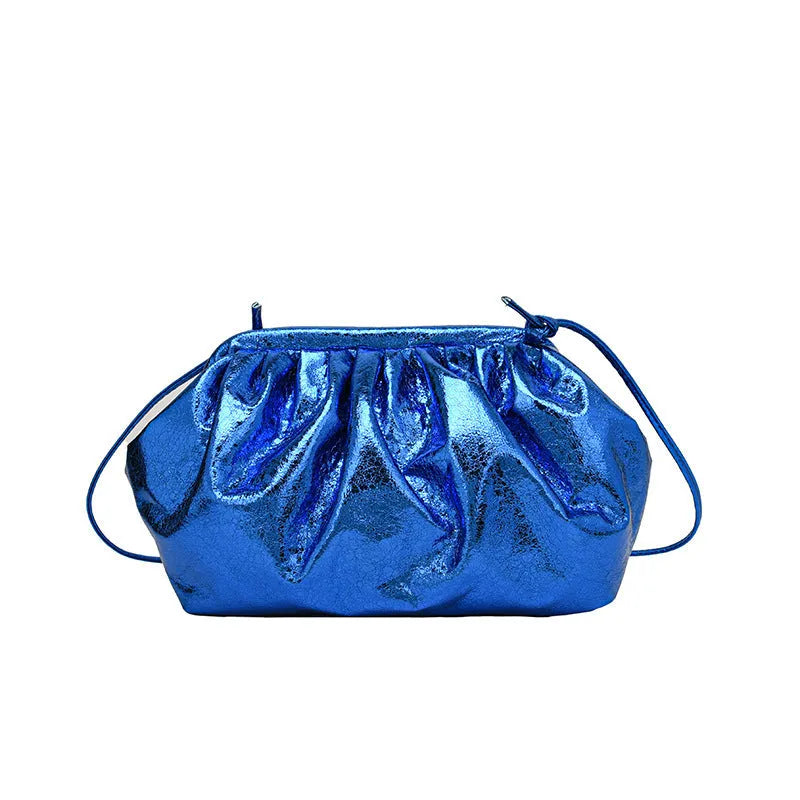 Shell-shaped crossbody bag with hair clip shoulder strap showing multiple compartments including mobile phone pocket