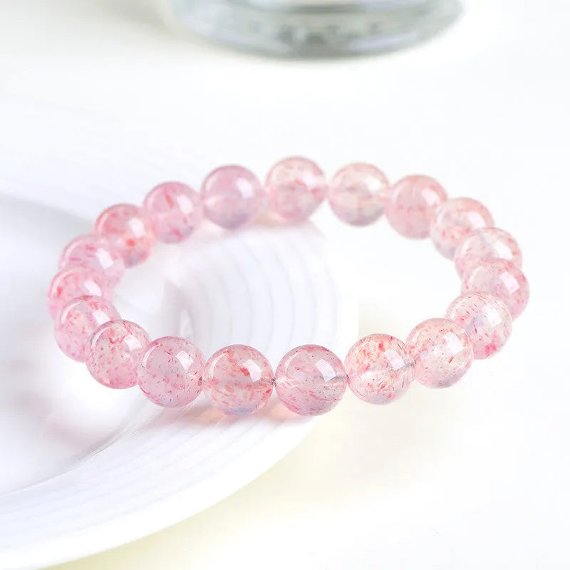 Natural white strawberry quartz ball bracelet with 10-10.8mm spherical beads.