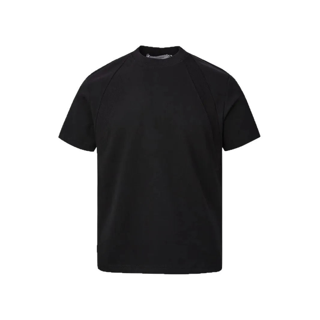 Man wearing a black loose-fit short sleeve top with visible air layer stitching texture.