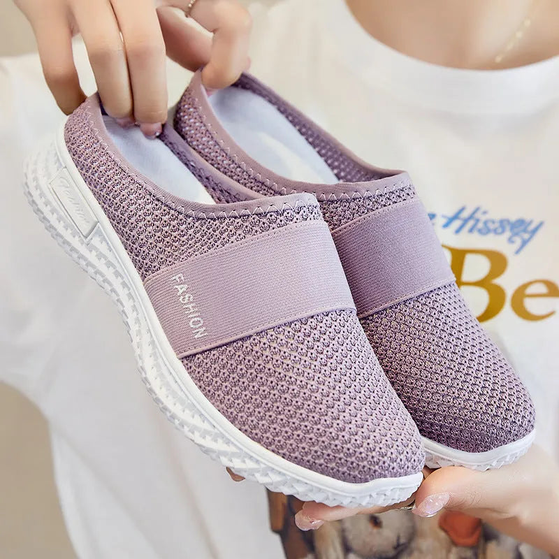 Women's breathable mesh casual shoes with flat heel, round toe, and hollow-out design in black, grey, pink, or purple.