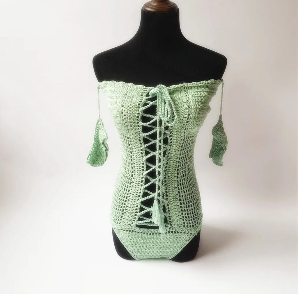 Off-shoulder one-piece swimsuit on a mannequin in light pink colour.