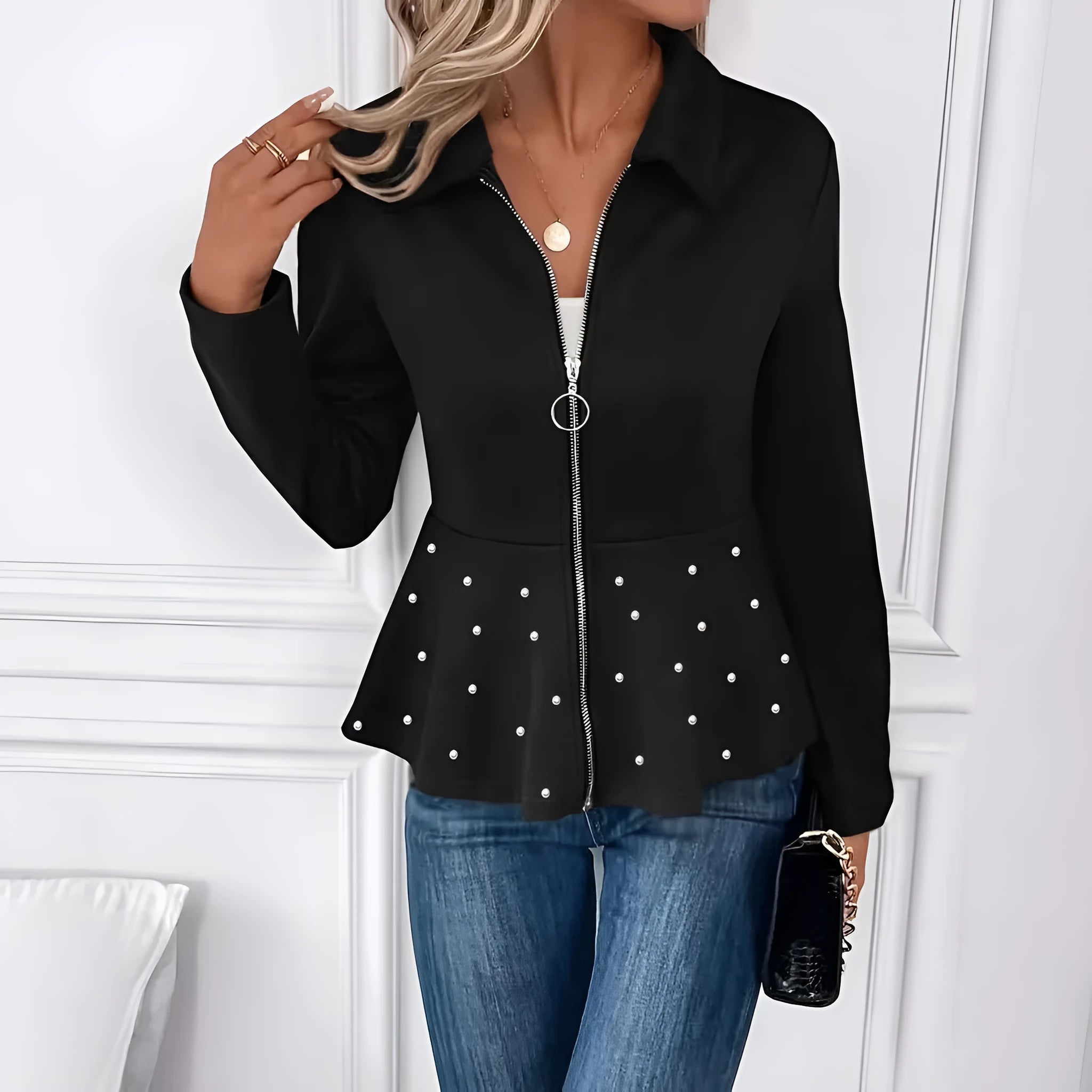 Women's loose black coat with beaded zipper and ruffled hem, shown on a hanger.