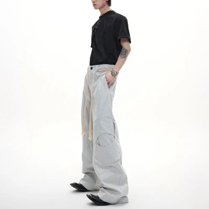 Men's dark blue straight-leg cotton jeans with heavy stitching on belt and zip decorations, shown in a loose fit.