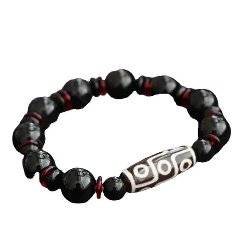 Black agate dzi bead bracelet with geometric pattern and hand-woven construction