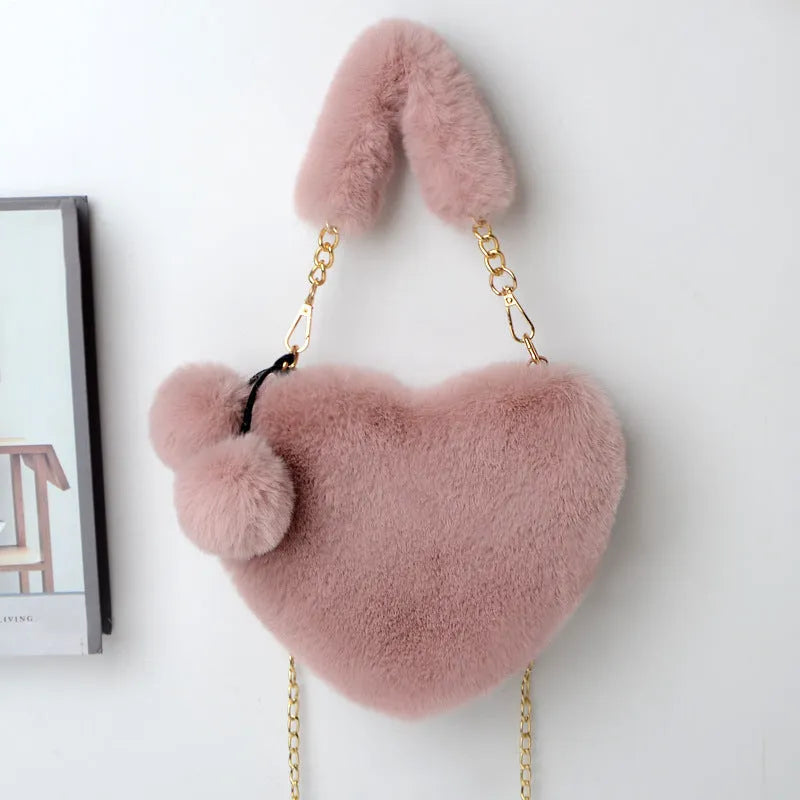 A soft plush heart-shaped women's handbag with a zipper and a detachable shoulder strap in a choice of 14 colours.