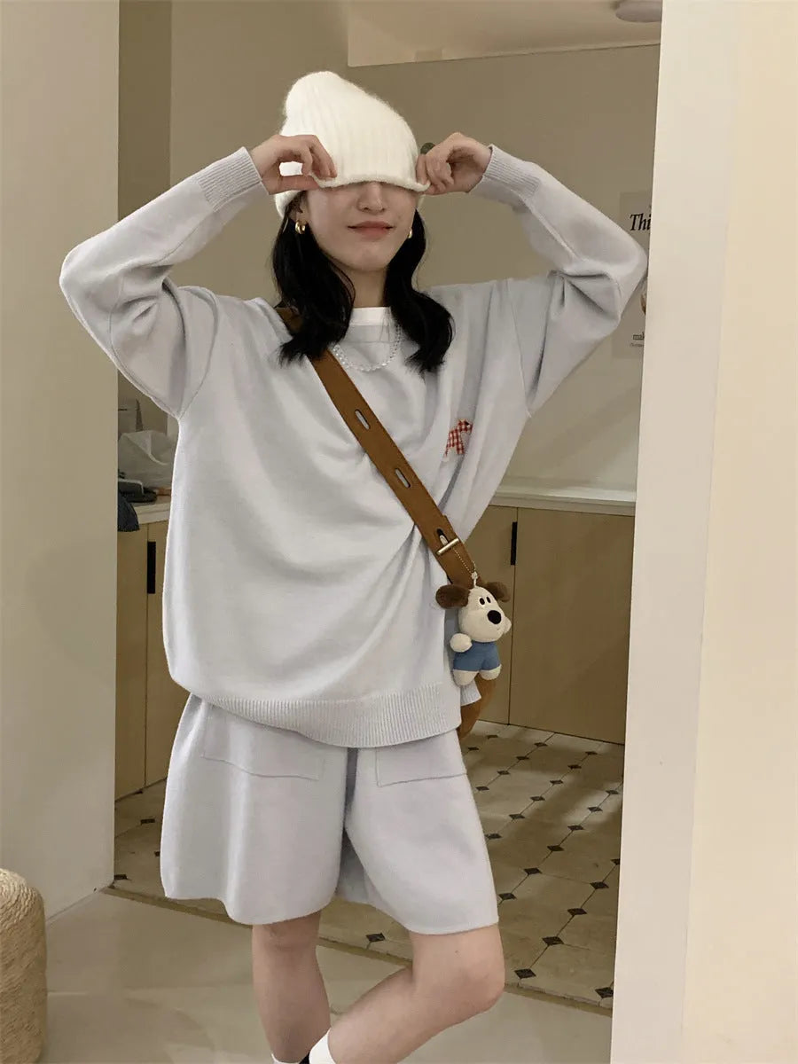 Women's milk blue casual knitted sports suit with animal embroidery on top and matching shorts.
