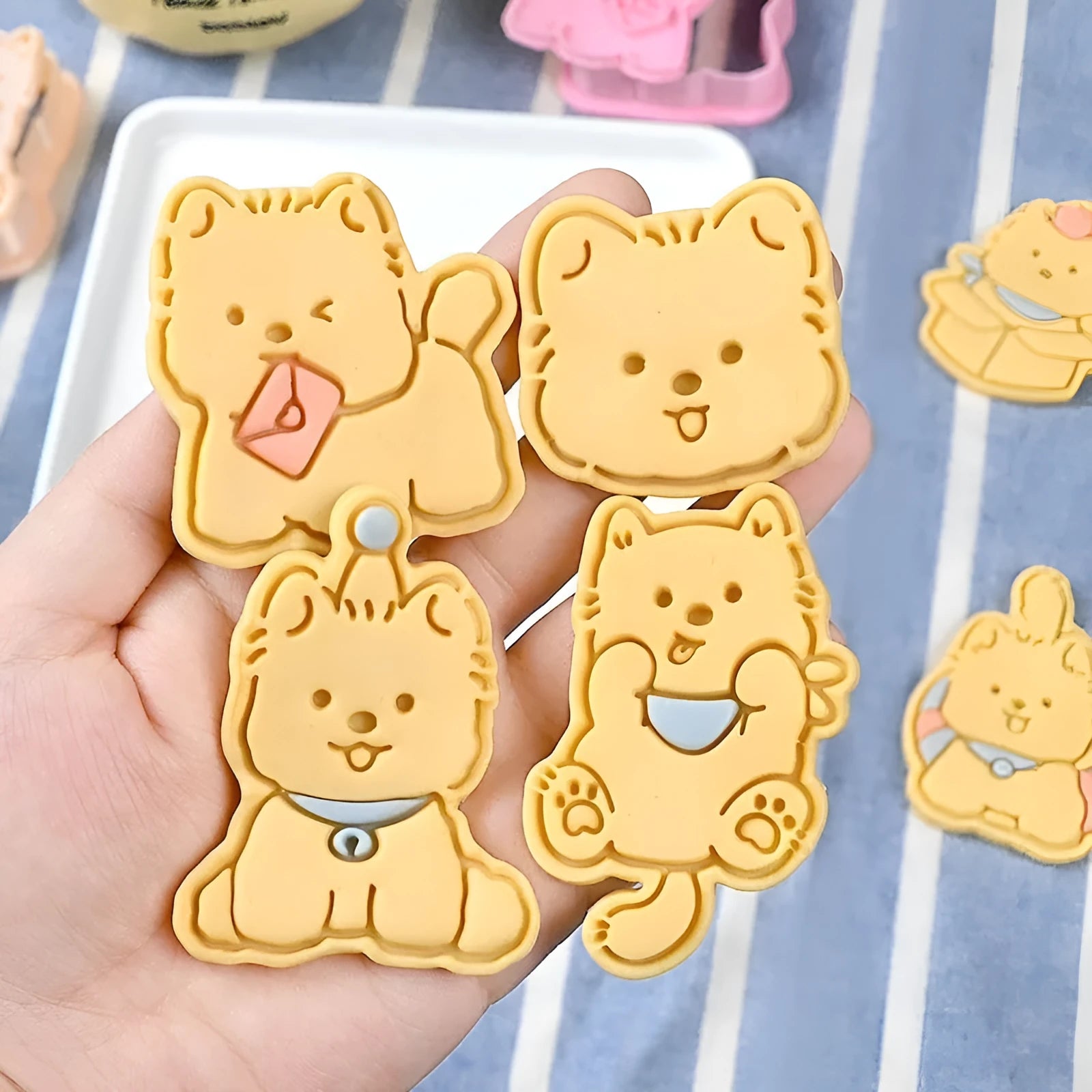 Plastic biscuit mould showing three-dimensional puppy head design with birthday hat for baking