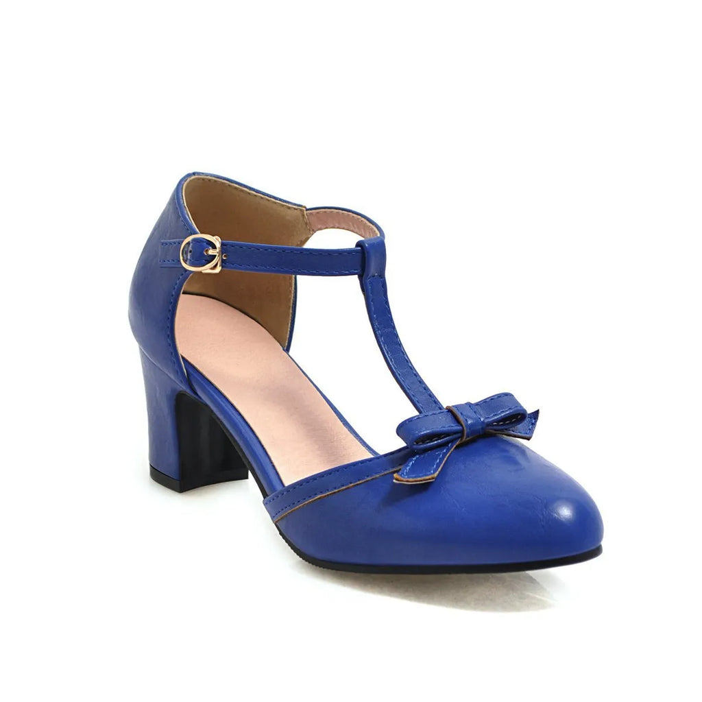 Yellow women's sandals with a chunky 6.5cm heel, bow tie detail, and buckle strap on a round toe.