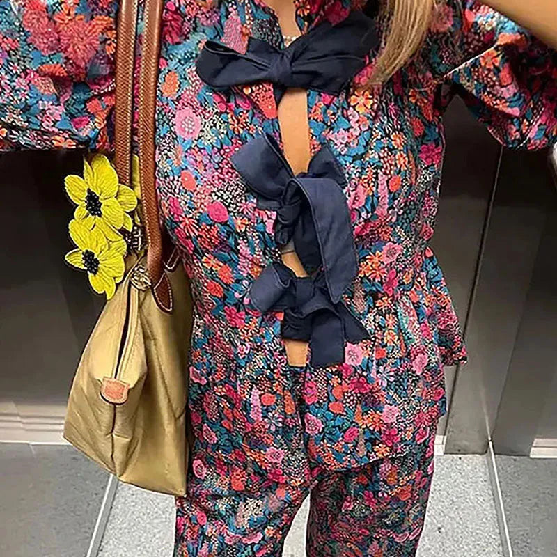 Women's floral print trousers suit with tie-neck top and puff sleeves
