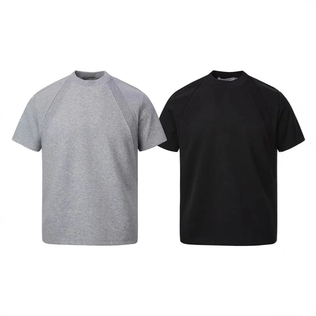 Man wearing a black loose-fit short sleeve top with visible air layer stitching texture.