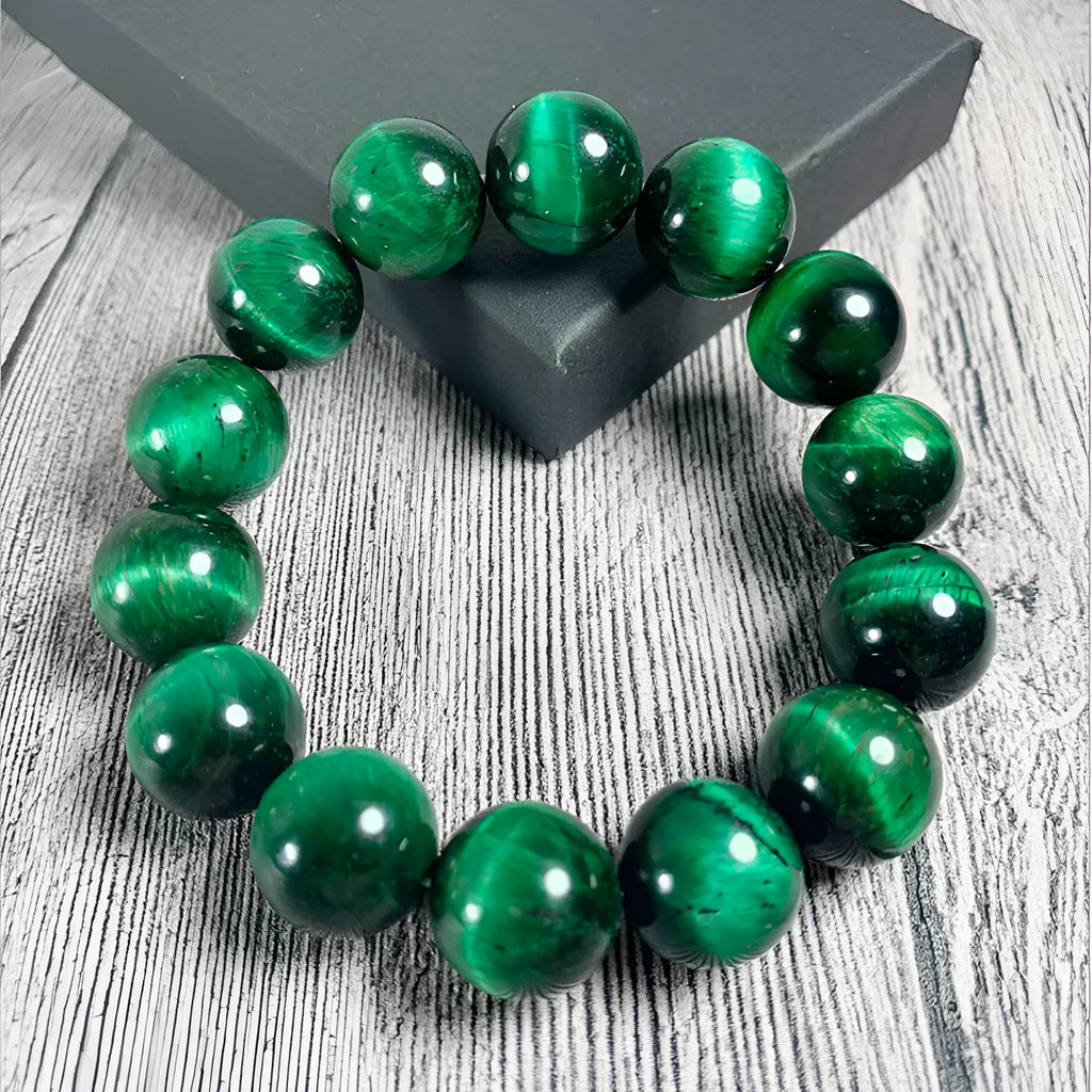 Green tiger eye stone bracelet with geometric beads on a wrist