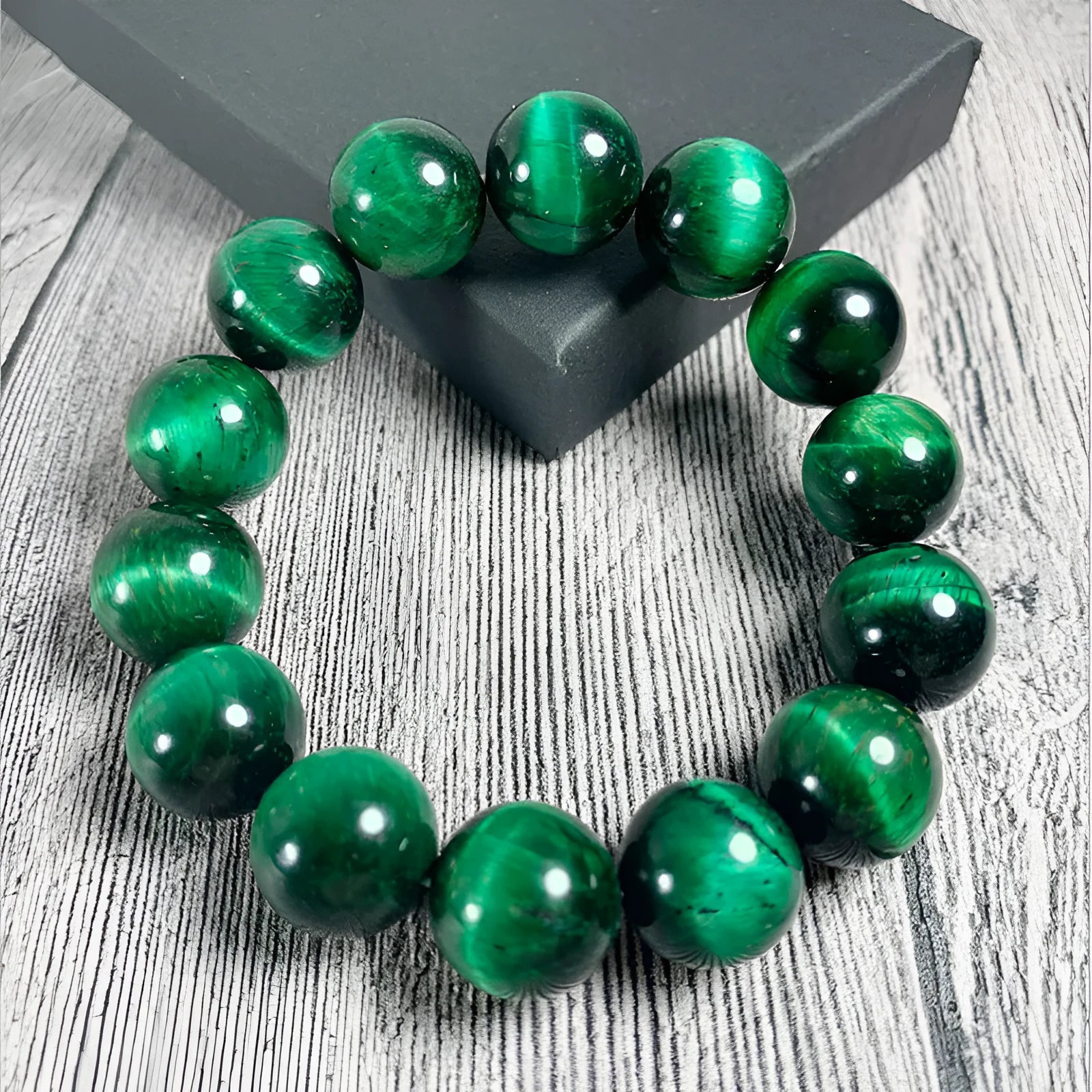 Green tiger eye stone bracelet with geometric beads on a wrist