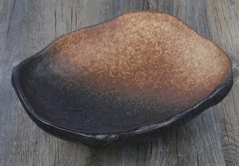 Japanese-style ceramic sashimi bowl with irregular shape and floral decoration