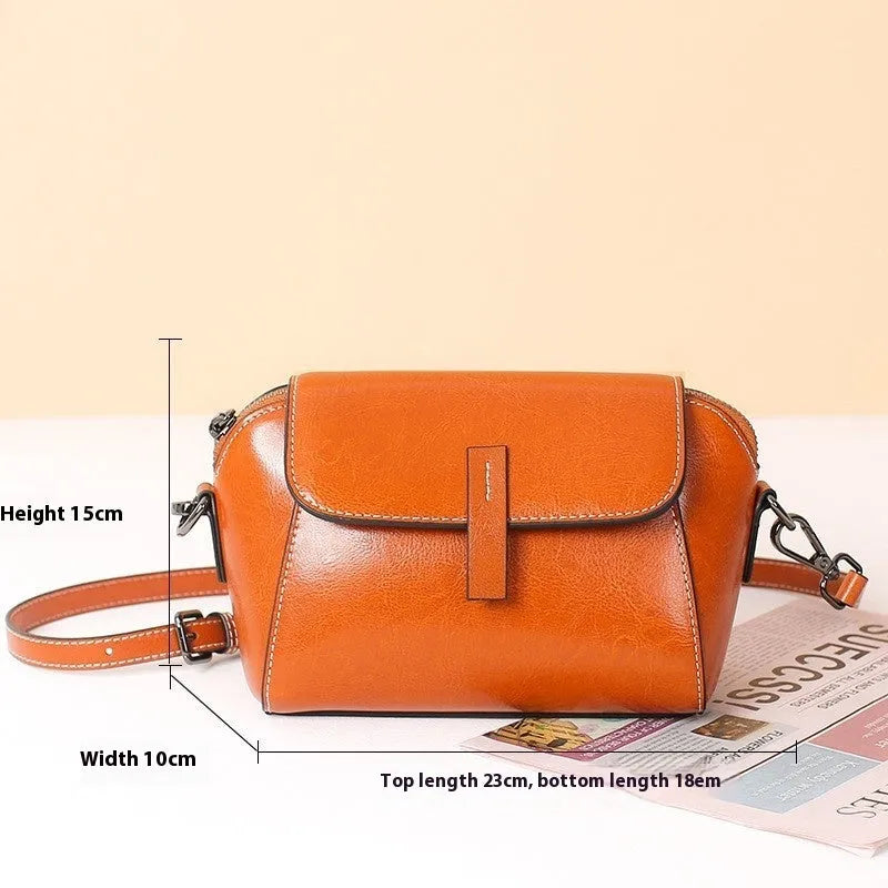 Women's brown oil wax leather messenger bag with crossbody strap and multiple internal pockets
