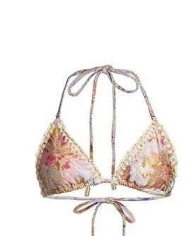 Women's creamy white floral bikini set with skirt cover-up on beach