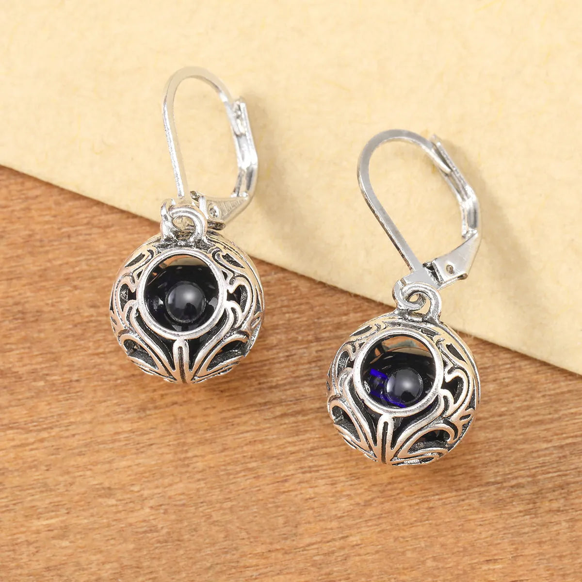 Vintage geometric silver tone pendant earrings with hollow blue gemstone setting