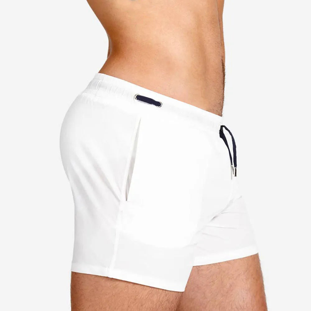 Men's solid colour mesh lining sports shorts for swimming and fitness in polyester fabric