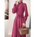 A rose red loose-fit turtleneck knit dress for women with long sleeves and a mid-length flared skirt.