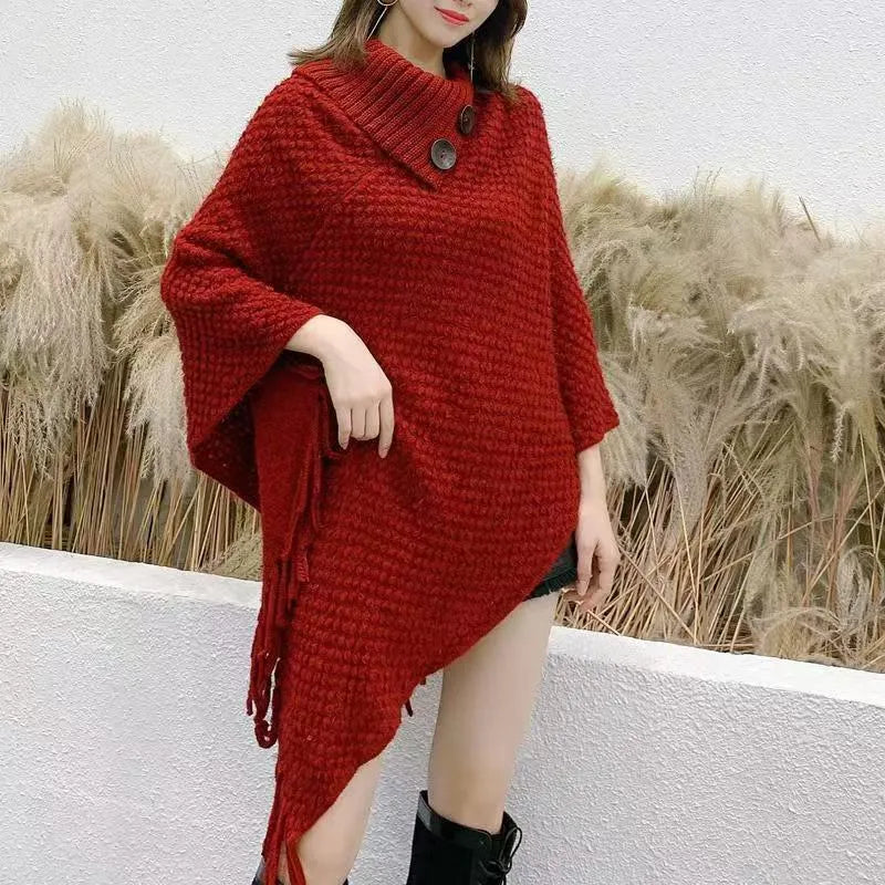 Women's triangular plush shawl cape with tassels in a cashmere and acrylic blend fabric.