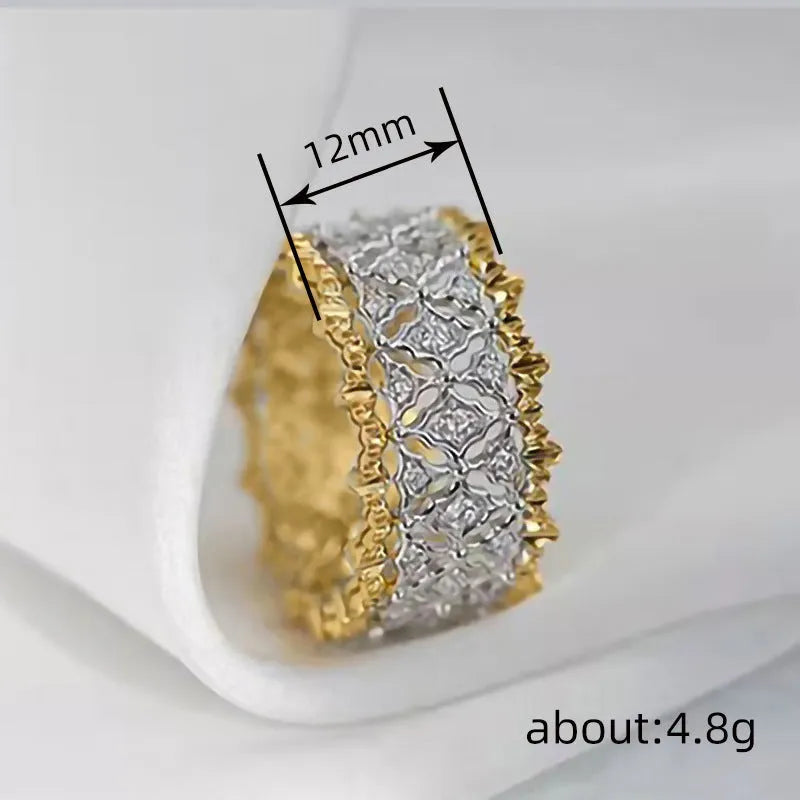 Geometric round two-tone gold zircon ring on a plain background, showing its electroplated copper construction.