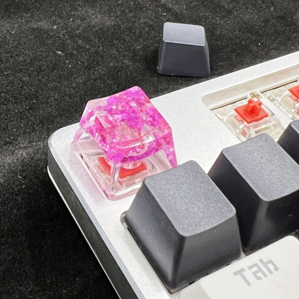 Resin starry sky artisan keycap in green, pink, red, or violet for mechanical keyboard customisation.