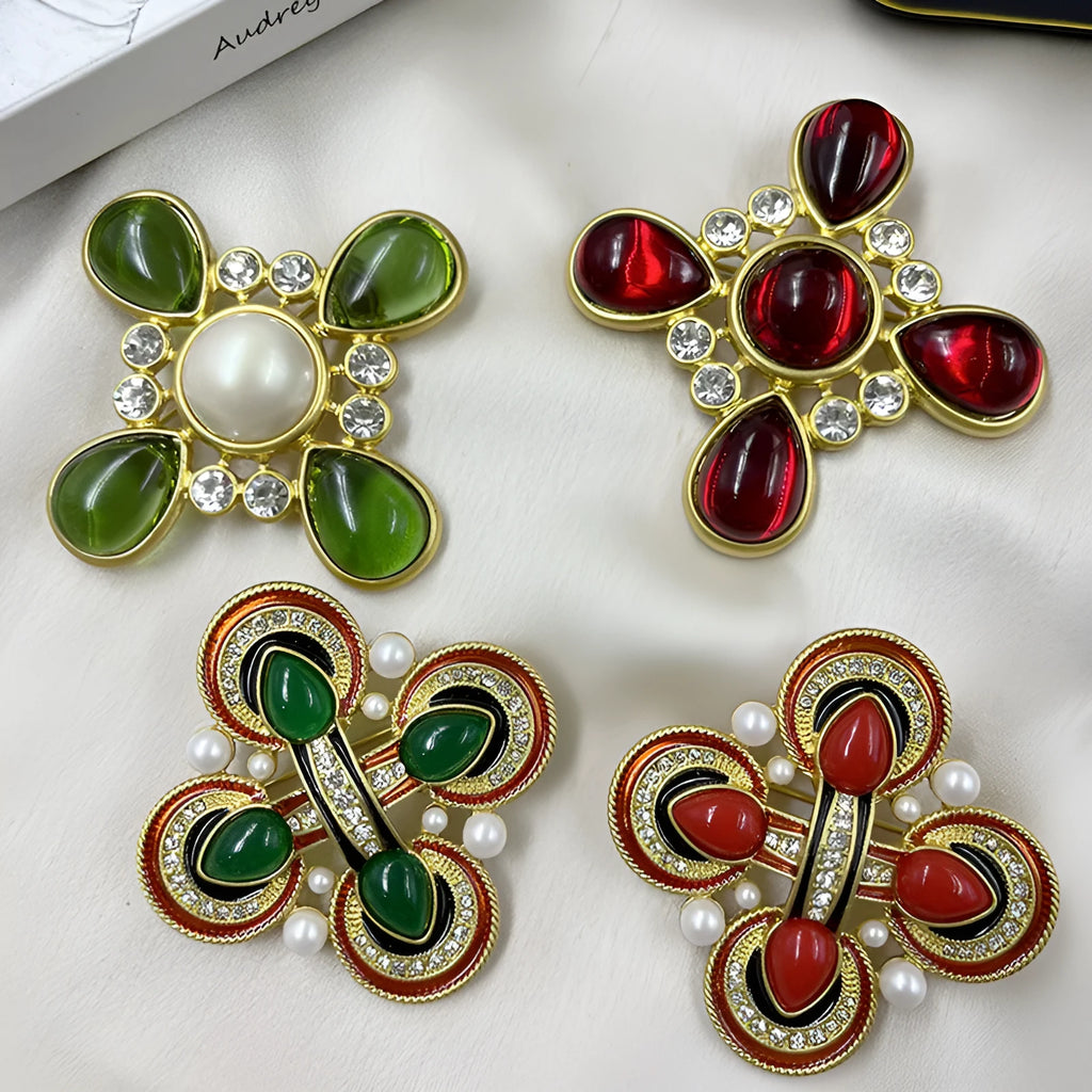 Close-up of vintage medieval baroque cross brooch with crystal details on zinc alloy base