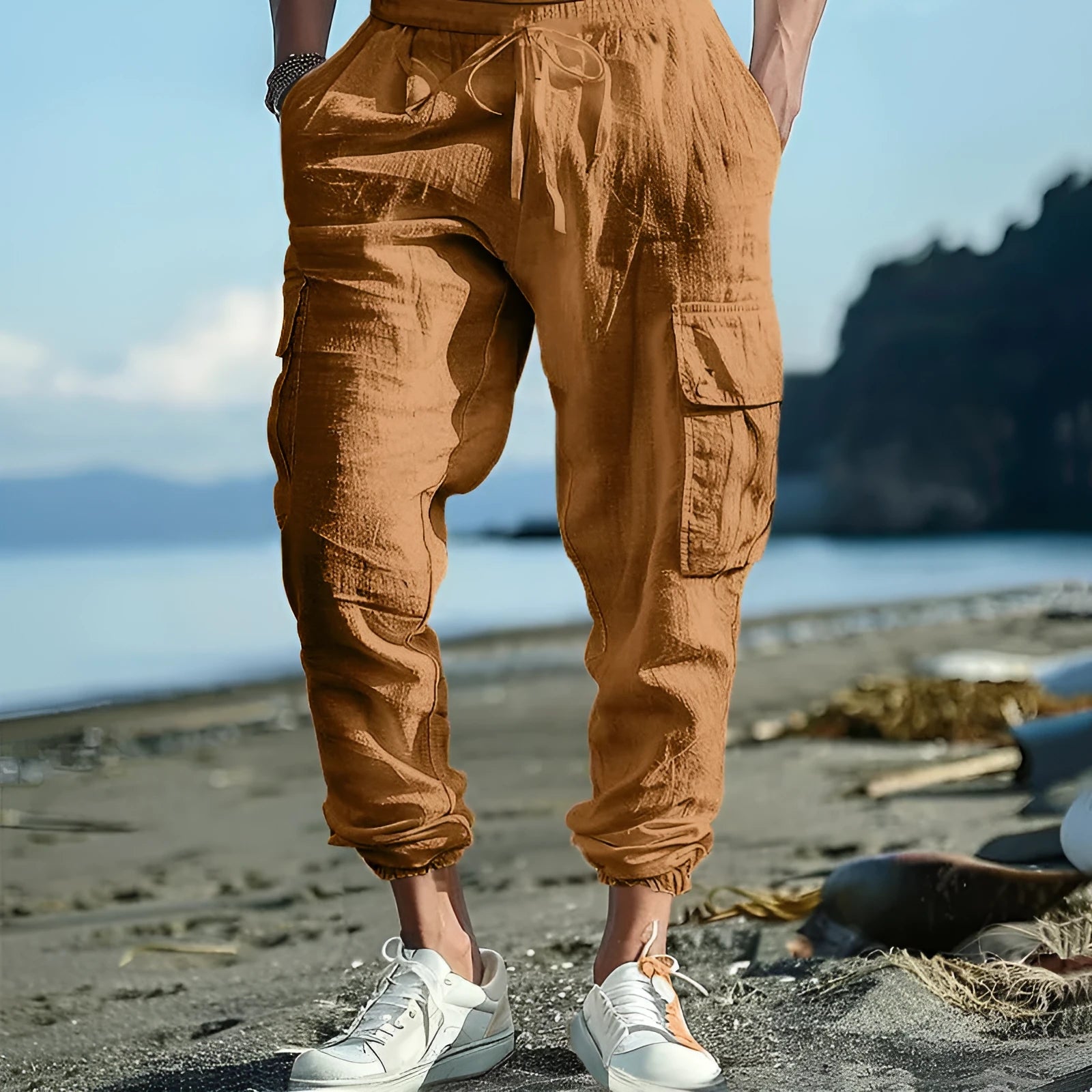 Men's loose-fit linen trousers with ankle-tied cuffs and multiple pockets.