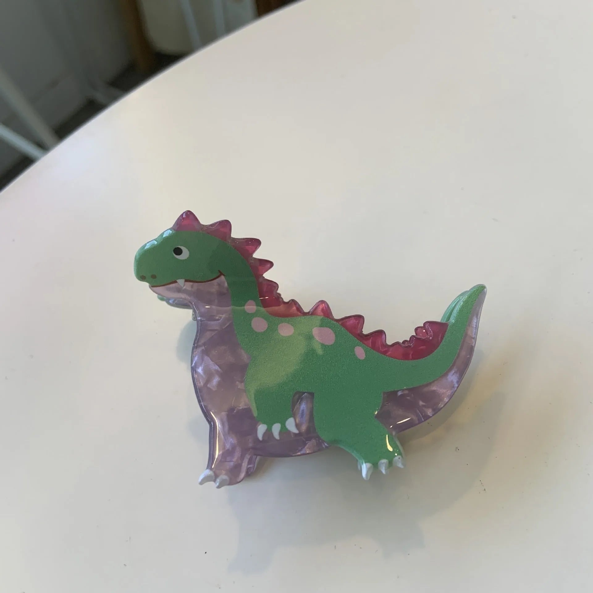 Colourful dinosaur acrylic jaw hair grip clip showing six design variations