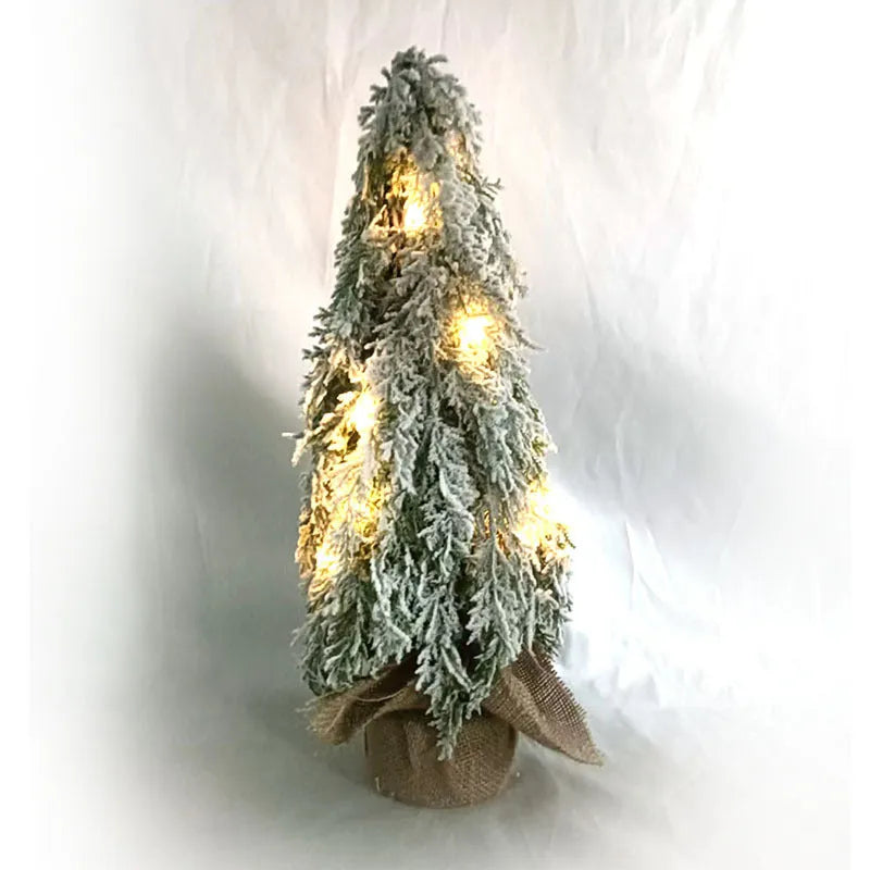 Small 24-inch white artificial Christmas tree with LED lights and snow spray on plastic branches