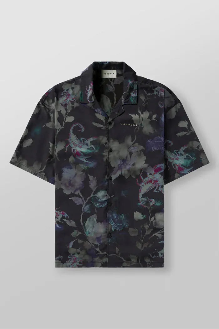 Man wearing a loose-fit, short sleeve floral print top in a neutral colour.