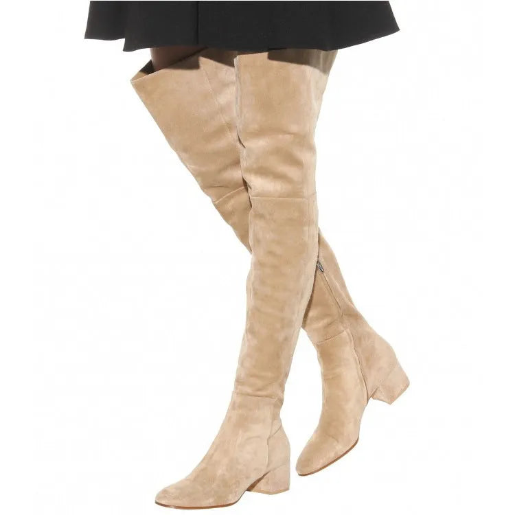 Women's grey suede over the knee flat boots with a pointed toe and low thick rubber sole.