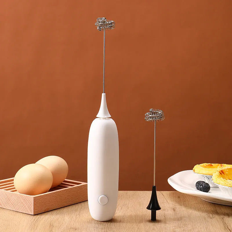 Handheld electric milk frother in black and white colours for making coffee and hot chocolate foam.