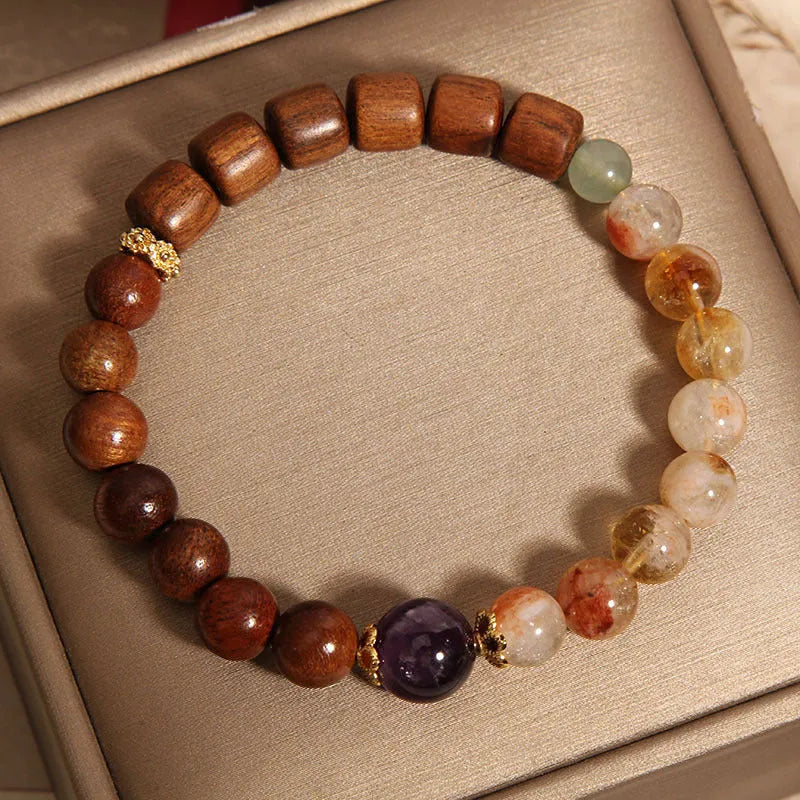 Women's adjustable crystal bracelet with yellow tower crystal, ebony amethyst, pearls, and rhinestones.