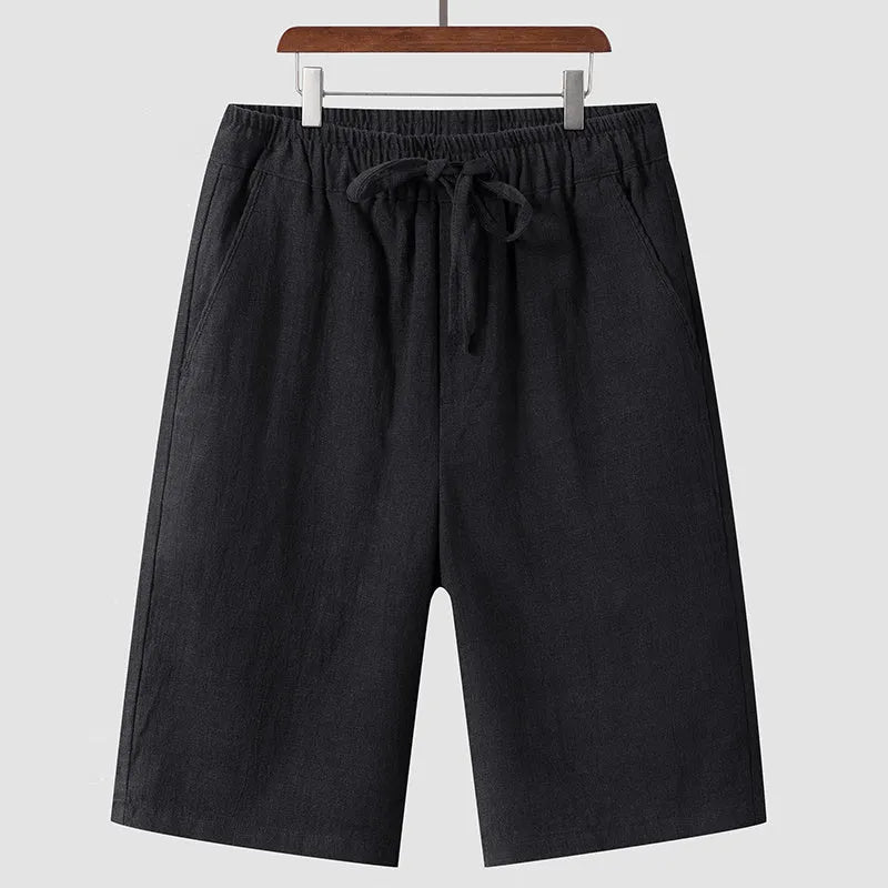 Men's linen shorts in loose cropped design with elastic waistband, shown in available colours