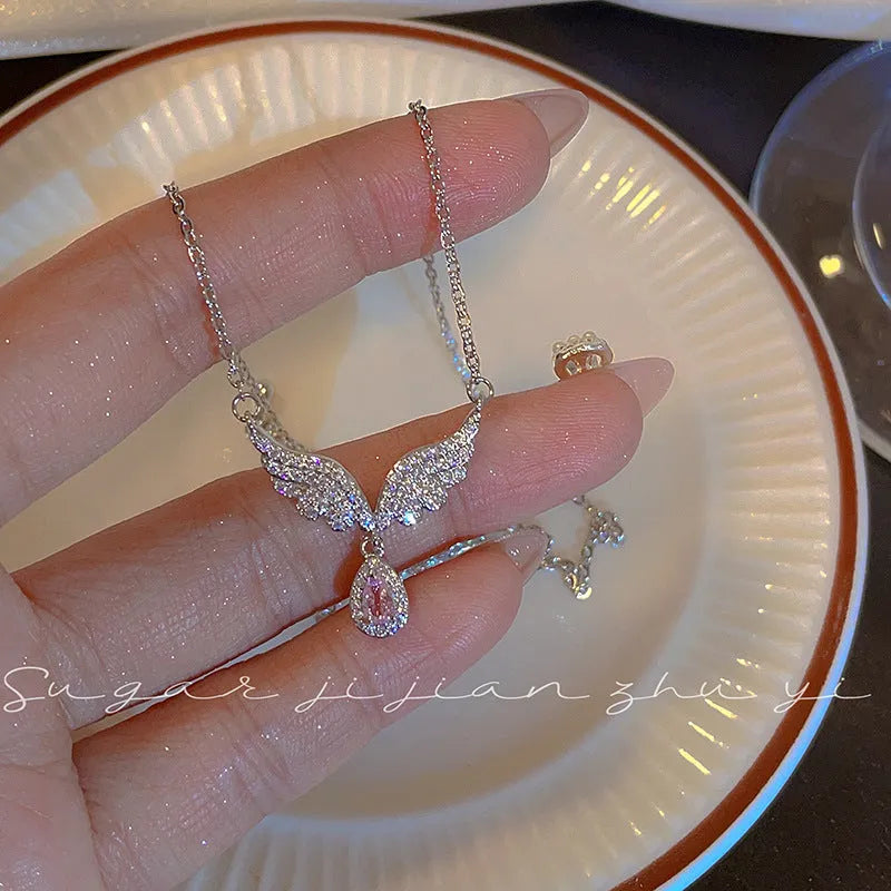 Close-up of a women's sterling silver fishtail pendant necklace on an adjustable O-ring chain.
