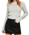 Long-sleeved slim fit acrylic knitted pullover sweater in light grey on a hanger.