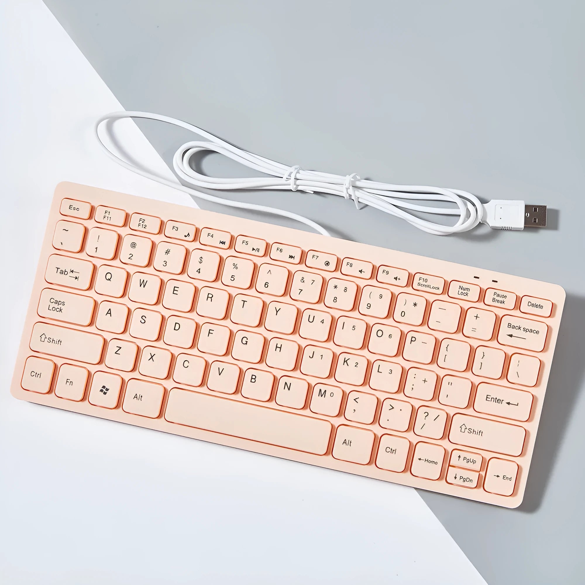 Compact black wired USB keyboard with noiseless keys on a desk.