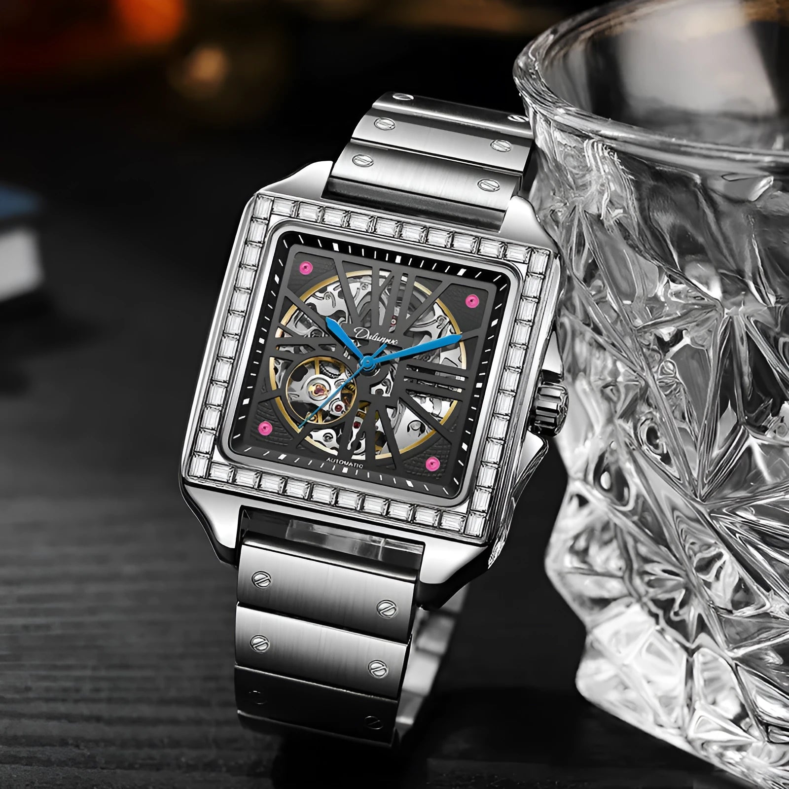 Square silver men's automatic watch with diamond-studded bezel on a black leather strap.