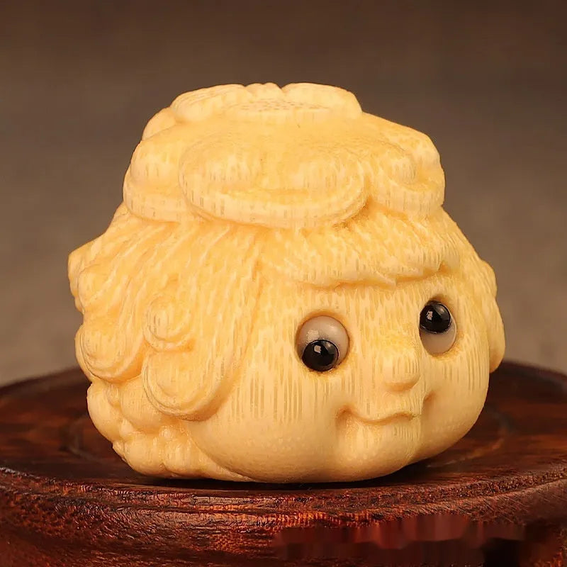 Solid bamboo golden toad princess ornament on a surface