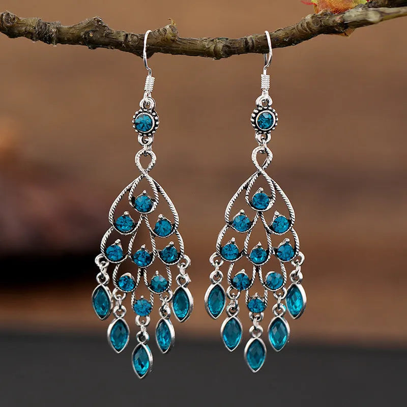 Pair of long purple drop earrings with a cascading fringe design and retro ethnic style.