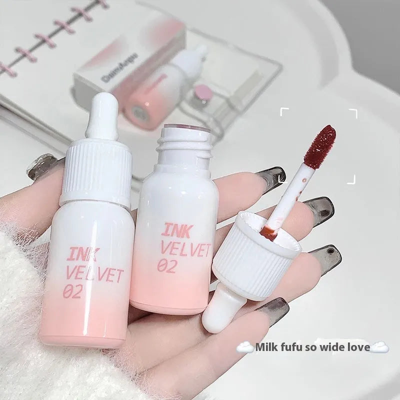 Mirror Lip Lacquer lip gloss tube in one of four shades: Spring Day Wilderness, Orange Tabby Cat Diary, Low-key Charming, or Misty Berry.