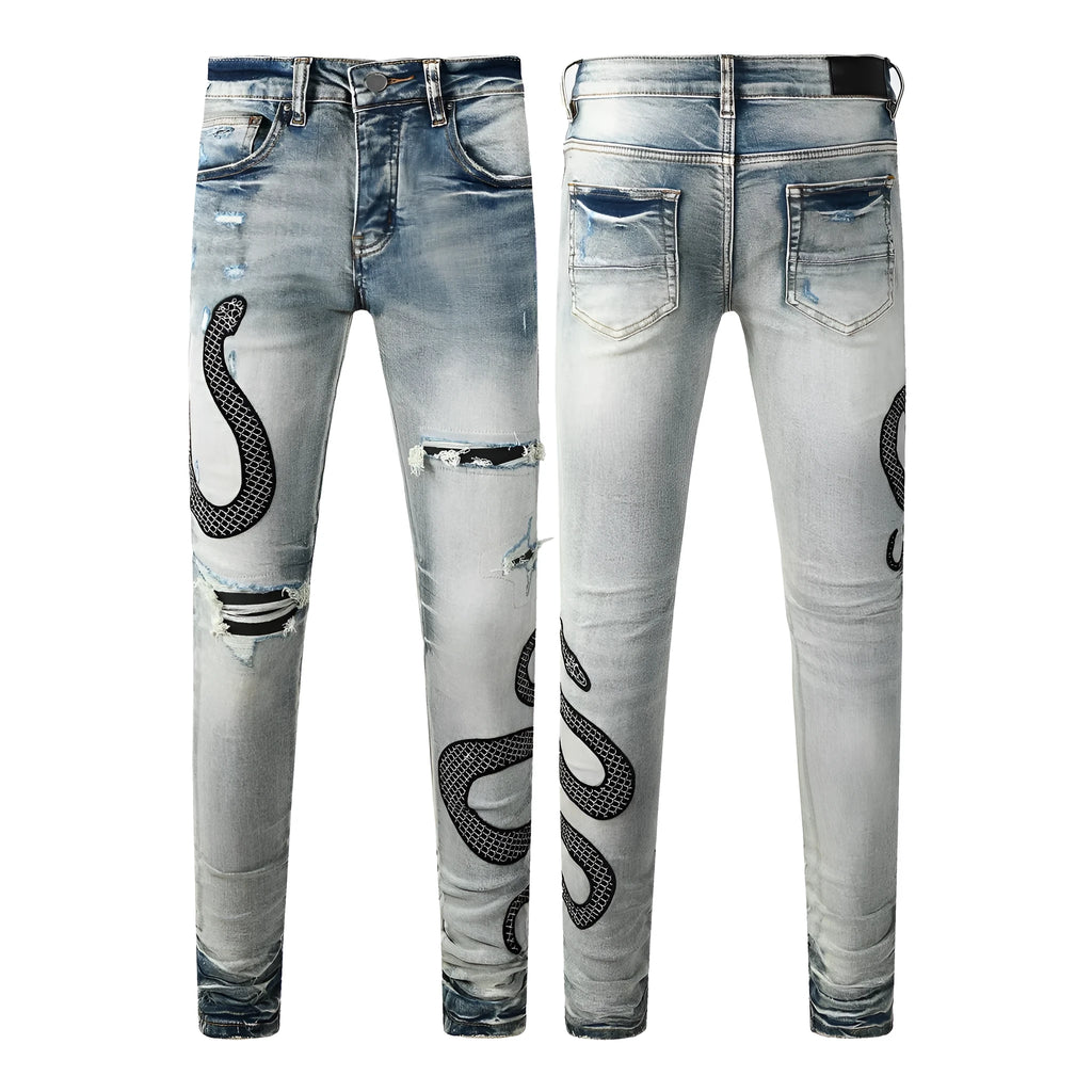 Man's blue distressed skinny jeans with a button fly and mid waist on a grey background.